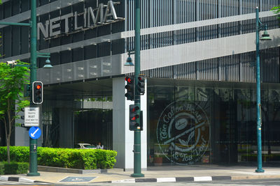 Road sign on street against buildings in city