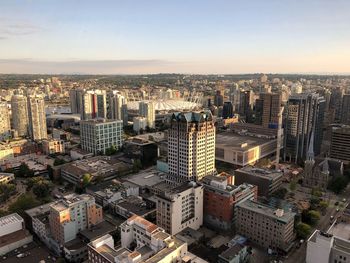 High angle view of modern buildings in city against sky