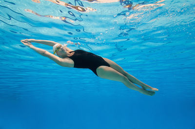 Woman swimming in pool