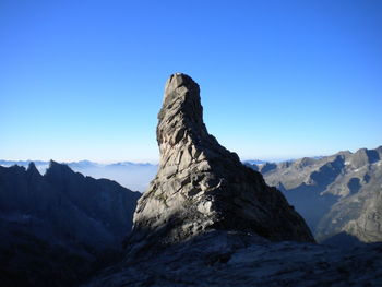 Scenic view of snowcapped mountains against clear blue sky