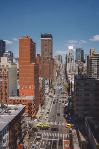 High angle view of street amidst buildings in city against sky