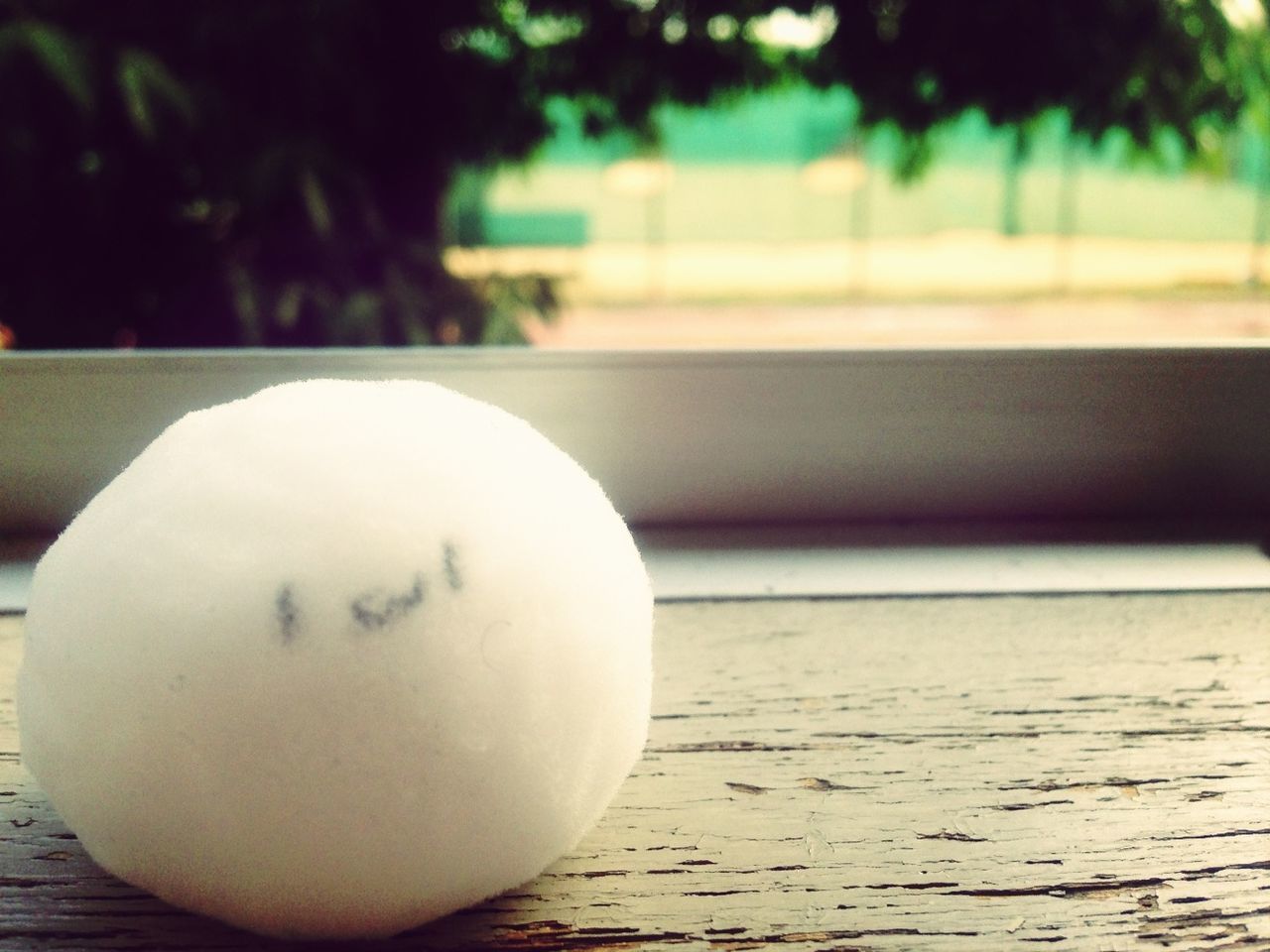 focus on foreground, close-up, indoors, table, still life, circle, no people, white color, selective focus, day, sphere, geometric shape, single object, ball, empty, white, shape, wood - material, absence