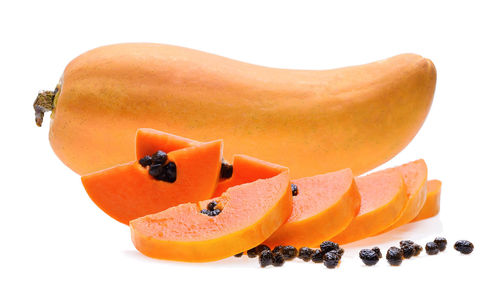 Close-up of papayas against white background