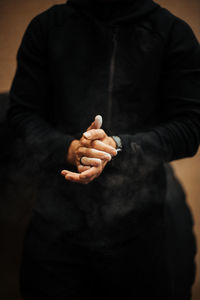 Close-up of man holding cigarette on hand
