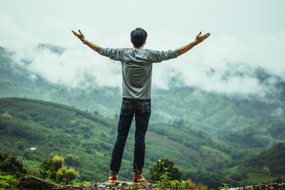 Rear view of man standing on mountain