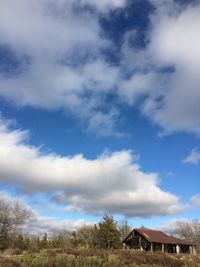 Scenic view of field against cloudy sky