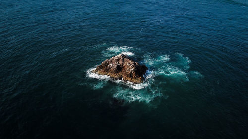 High angle view of rock in sea