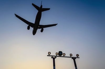 Airplane landing at berlin tegel airport at dusk