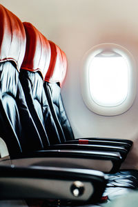 Image of empty airplane seats and window. airplane interior background