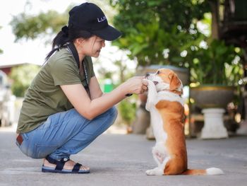 Woman with dog sitting outdoors