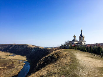 View of statue on mountain against blue sky