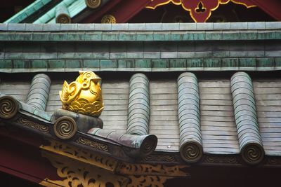 Low angle view of statue against building