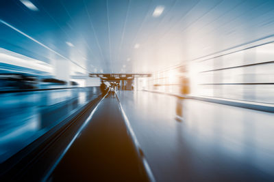 Blurred motion of train at railroad station