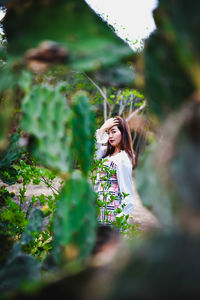 Side view of young woman standing outdoors