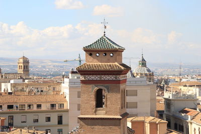 Buildings in city against sky