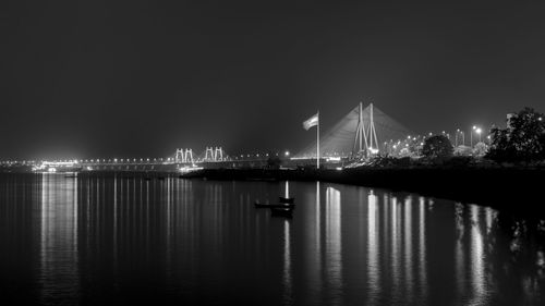 Sailboats in sea against clear sky at night