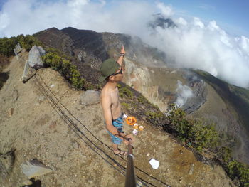 Man standing on rock against mountains