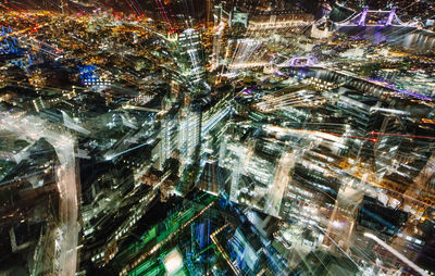 High angle view of city lit up at night