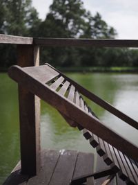 Close-up of railing on bridge over river