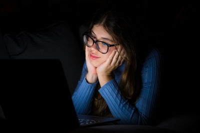 Young woman using laptop at home