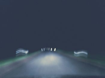 Close-up of illuminated car on road at night