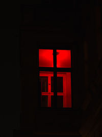 Close-up of illuminated sign in darkroom