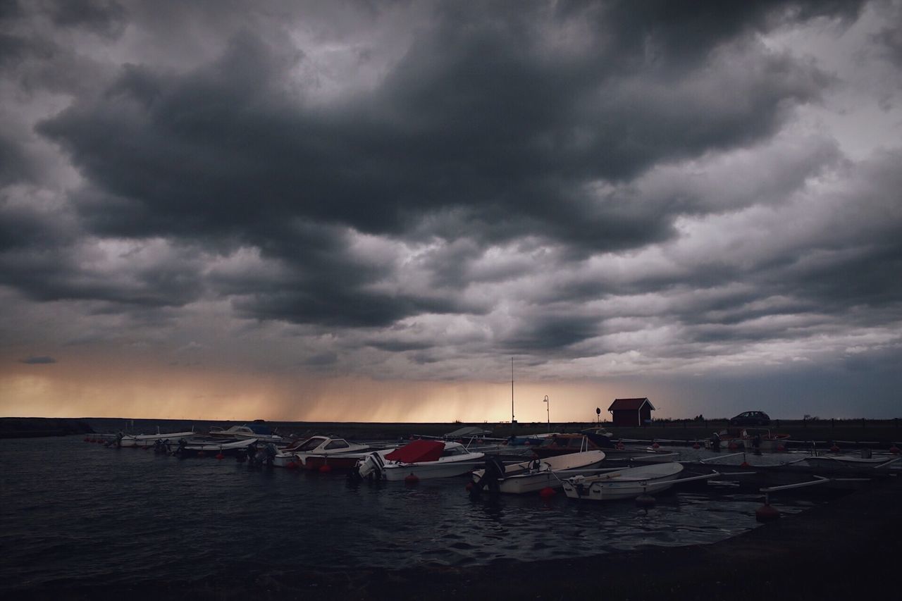 cloud - sky, sky, storm cloud, dramatic sky, weather, nature, sea, atmospheric mood, sunset, nautical vessel, scenics, beauty in nature, dusk, tranquility, outdoors, no people, water, horizon over water, built structure, beach, tranquil scene, moored, architecture, building exterior, thunderstorm, day, city