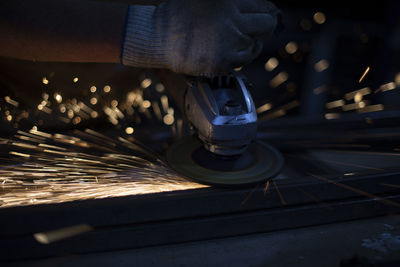 Grinding of steel. sparks from metal. hot particles. small lights. work on metal profile.