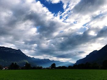 Scenic view of green landscape against sky