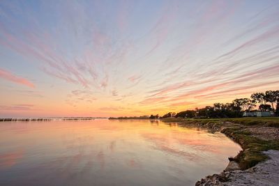 Scenic view of sea against romantic sky at sunset