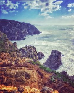 Scenic view of sea against cloudy sky