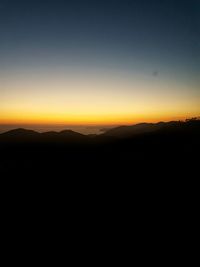 Scenic view of silhouette landscape against clear sky during sunset