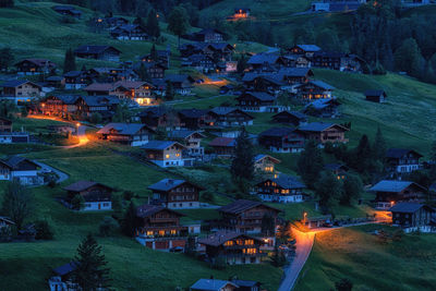 High angle view of illuminated buildings in city at night