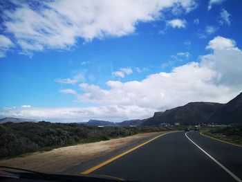 Road passing through mountains against sky