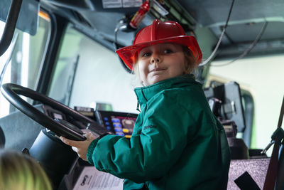 Rear view of man working in factory