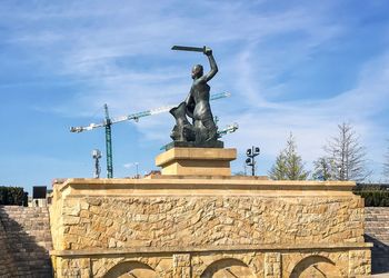 Low angle view of statue against cloudy sky