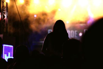 Rear view of silhouette people at music concert