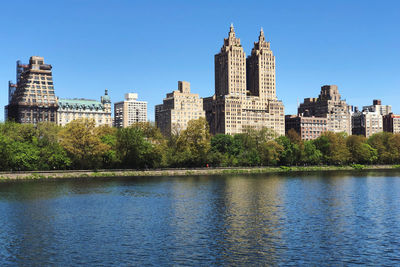 Buildings in city against blue sky