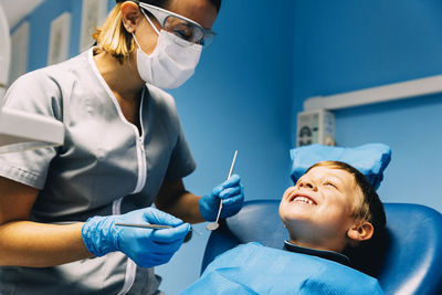 Dentist examining patient in clinic