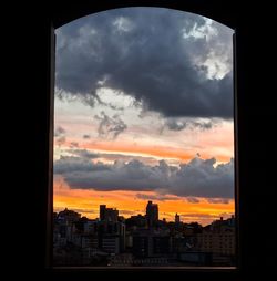 Silhouette buildings against sky during sunset