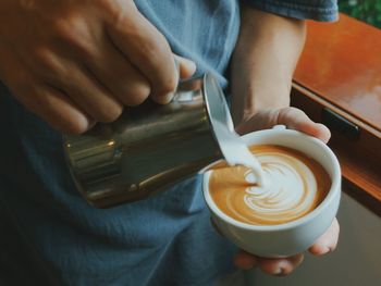 Midsection of man holding coffee