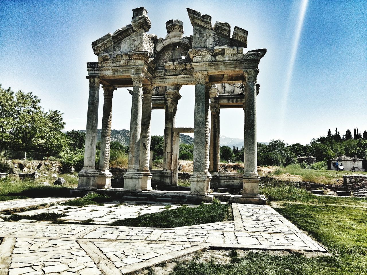 architecture, built structure, history, famous place, religion, travel destinations, tree, building exterior, spirituality, the past, statue, place of worship, travel, tourism, sky, architectural column, monument, sculpture, stone material, art