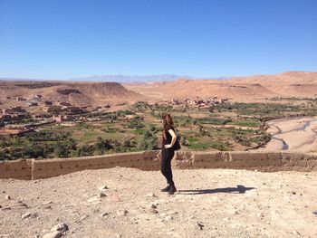 Full length of woman looking at mountains while standing on observation point