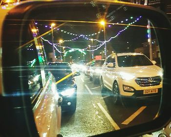 Illuminated car in city at night
