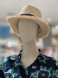 Close-up of hat on sofa against store