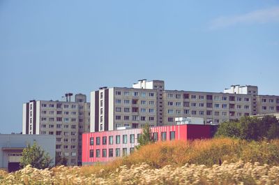 Low angle view of buildings against clear blue sky