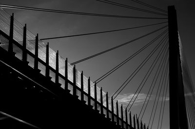 Low angle view of suspension bridge against sky