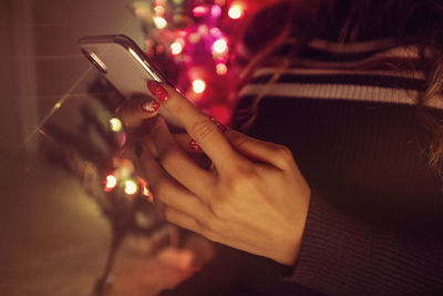 Midsection of woman using mobile phone