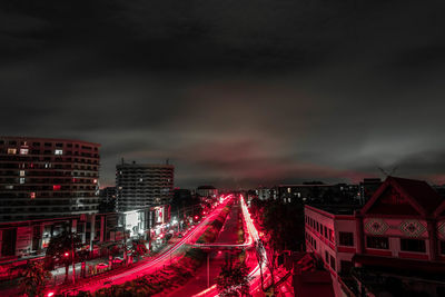 Illuminated city buildings against sky at night