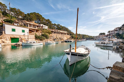 Boats in river with buildings in background